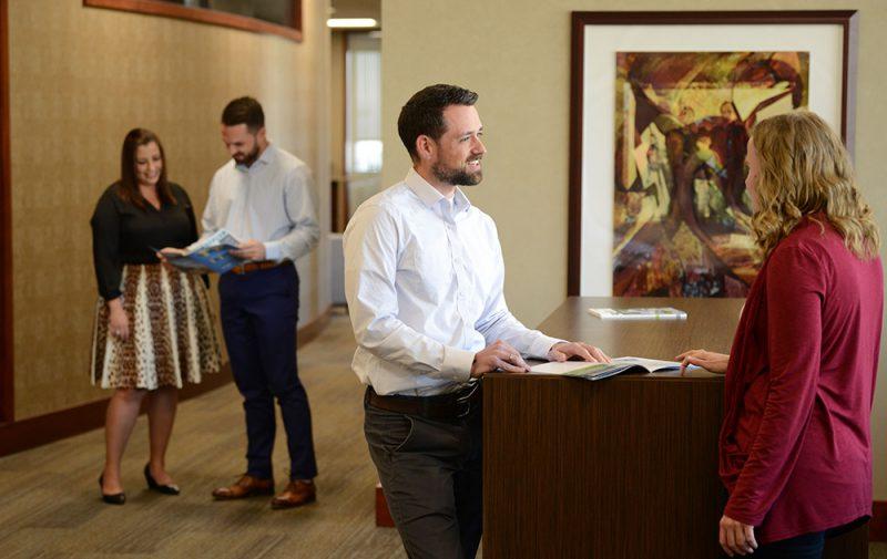 Image of male and female office workers in a corporate setting.